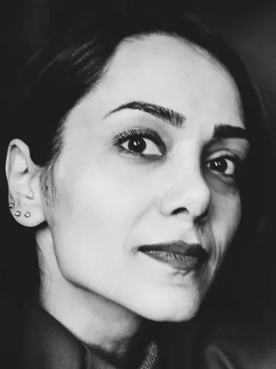 Black-and-white portrait of a woman in her forties with a confident half smile