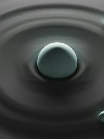 A single drop rising from rings of still water