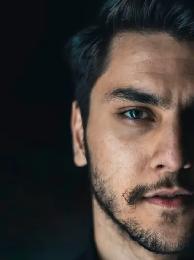 Close-up of a man's face half in shadow